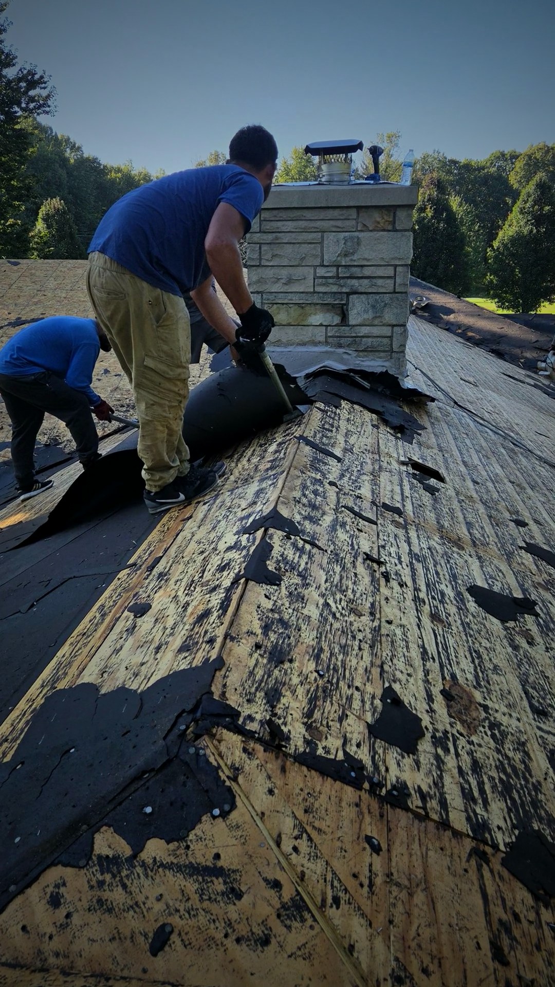 Middle of the project with the roofing crew removing the remaining old material around the chimney